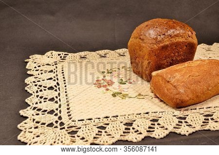Delicious And Fragrant Bread With Toasted Crust On An Embroidered Linen Napkin