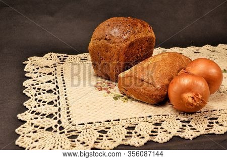 Mouth-watering And Fragrant Bread With Toasted Crust And Onions On An Embroidered Linen Napkin