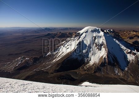 View Of Pomerape Volcano From The Top Of Parinacota Volcano.