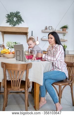 Young Mom Working At Laptop, Daughter Interfering