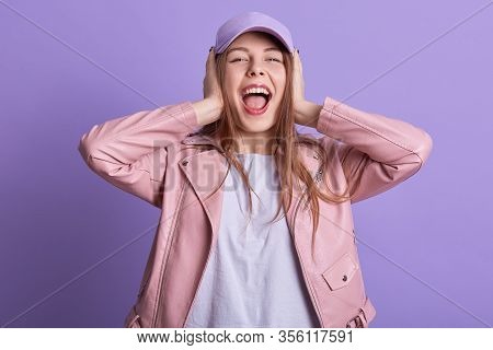 Attarctive Woman In Leather Pink Jacket Covering Ears And Feeling Irritation From Loud Repairing Wor