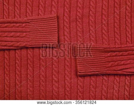 Close Up Background Texture Of Red Cable Knitted Wool Jersey Fabric Sweater With Row Braid Pattern