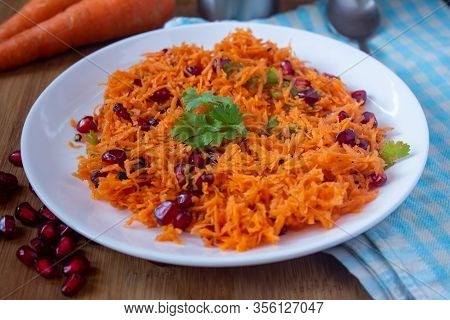Salad Of Carrot And Pomegranate Seeds With Cilantro Topping. Healthy Snack Rich In Antioxidants. Use