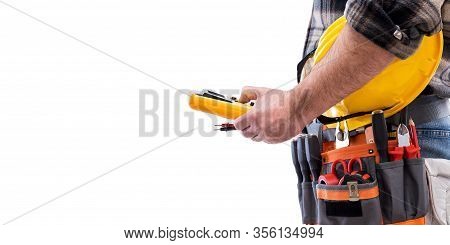 Electrician Holds Multimeter Tester In Hand, Helmet With Protective Goggles. Construction Industry, 