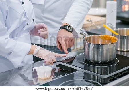 Chef Shows How To Use Electric Stove At Cuisine Of Restaurant. Professional Cooking, Training, Educa