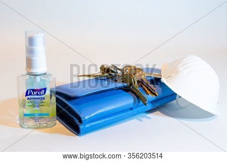 St Elizabeth, Jamaica - March 06 2020: Purell Advanced Hand Sanitizer Gel, Mask, Keys, Purse On Whit