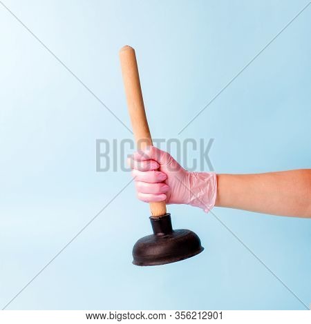 Hand In Pink Glove Holding Domestic Plunger. Concept Of Cosmetology Device For Skin Cleaning And Hom