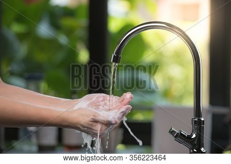 Hands Being Washed Scrubbed And Rinsed Using Disinfectant Soap For Hygiene And Protection Against Co