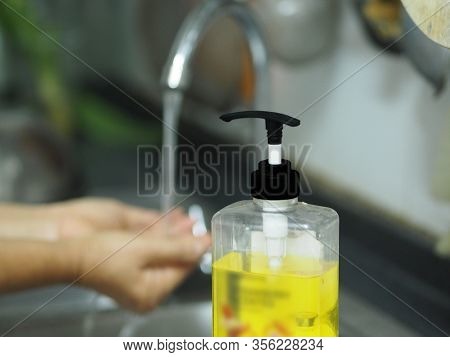 A Woman Standing And Washing Her Hands At The Sink To Prevent Germs Protect Colona Virus, Covid 19