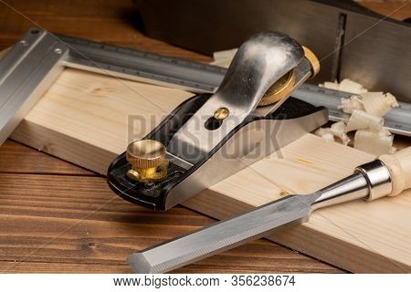 Chisel And Small Block Plane With Wood Shavings