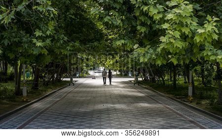 Asjchabad, Turkmenistan - June 1, 2019: Empty Parks In Turkmenistan With Fallen Tricycle And People.