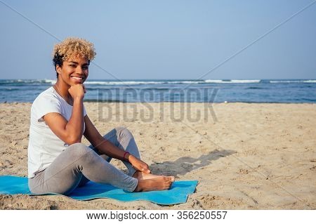 Brazilian Hispanic Woman Training Yoga On The Beach