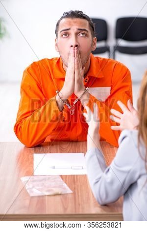 Young man meeting with advocate in pre-trial detention