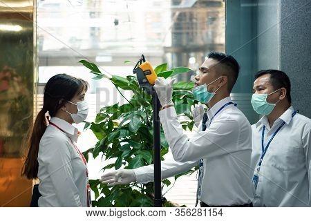 People Waiting For Temperature Check By Thermoscan