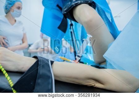 Hand And Foot Of The Patient. The Patient Lies On The Operating Table. A Catheter With An Anesthesia