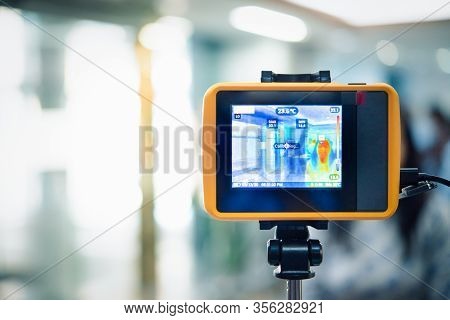 People Waiting For Temperature Check By Thermoscan