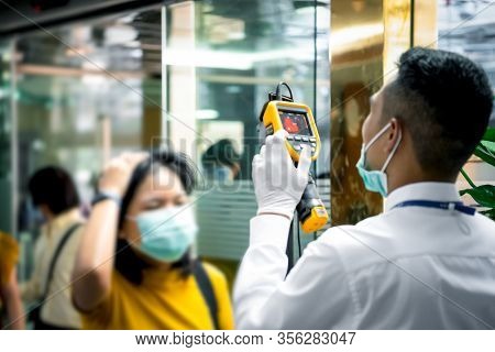 People Waiting For Temperature Check By Thermoscan