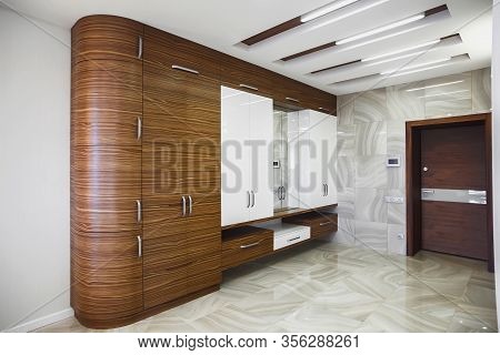 Wooden Cabinet In Modern Hallway Interior With Marble Floor