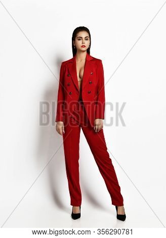 Self-confident Sexy Brunette Woman Is Posing In Stylish Red Office Pantsuit Jacket On The Naked Body