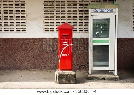 Samut Songkhram, Thailand - October 30 : Old Public Telephone In Booth And Red Post Box On Pathway F
