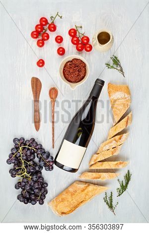 Bottle Of Red Wine, Grapes, Bread And Tomatoes For Buffet Party. Traditional French Or Italian Entir