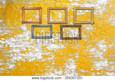 Vintage Photo Frames On Grunge Gloden Wall For Interior Or Background.