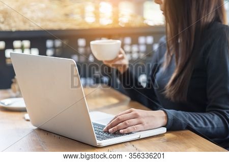 Business Woman Working On Laptop And Drinking Coffee At Home Office,student Typing Report And Resear