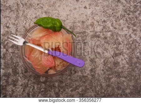 Pomelo (robab Tenga) Citrus Fruit Inner Parts With Ghost Chili Pepper (bhut Jolokia) And Fork Spoon 