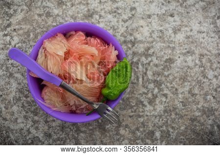 Pomelo (robab Tenga) Citrus Fruit Inner Parts With Ghost Chili Pepper (bhut Jolokia) And Fork Spoon 