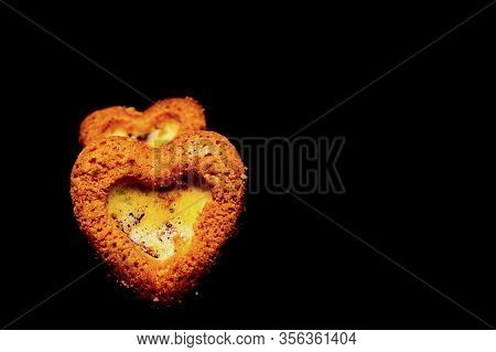 Heart Shaped Sponge Cake. Bakery Products. Black Background.