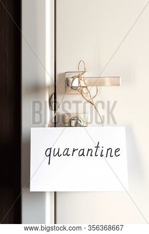 On The Door Handles A Sign On Paper With The Signature Quarantine. The Concept Of Self-isolation Dur