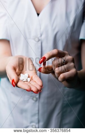 A Close-up Shot - A Hand With Pills And Drugs Shows What Pills Should Be Taken So As Not To Get The 