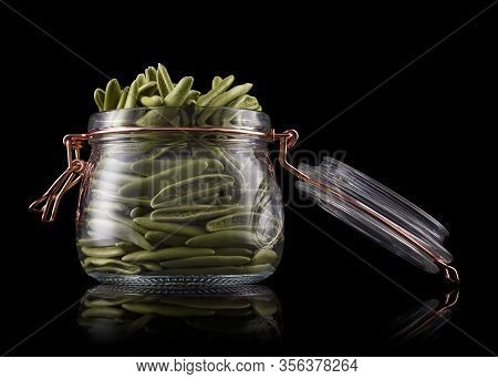 Jar Of Foglie Spinach Pasta On Wooden Table Isolated On Black Background