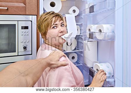 Woman With Toilet Paper By The Refrigerator Was Caught Her Husband During Nightly Meal. Prank Of Ove