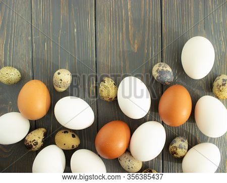 Easter. Chicken And Quail Eggs Of Natural Colors On A Wooden Background. Flat Lay