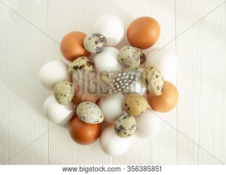 Easter. Chicken And Quail Eggs Of Natural Colors On A Wooden Background. Flat Lay