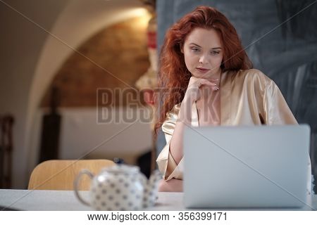 Nice beautiful lady work at the notebook sit  at home - check on oline shops for cyber monday sales - technology woman concept for alternative office freelance. virus epidemic allert