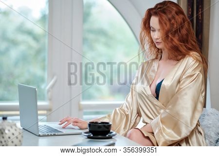 Nice beautiful lady work at the notebook sit  at home - check on oline shops for cyber monday sales - technology woman concept for alternative office freelance. virus epidemic allert