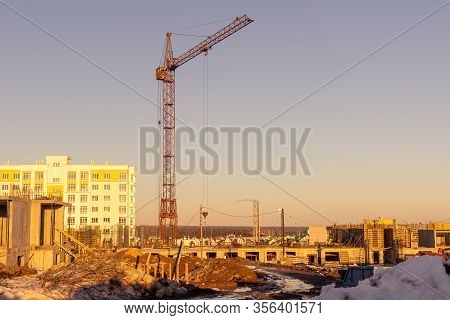 On A Spring Evening, A Tower Crane Builds Buildings On The Outskirts Of The City
