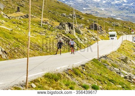 Sognefjellet, Norway - July 7, 2018: People Riding On Roller Skis In Mountains On National Tourist R