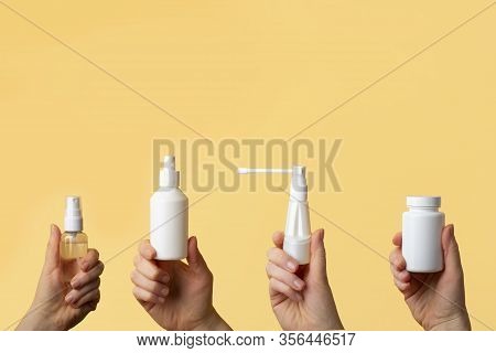 Viral Disease Prevention Concept. Woman Hands Holding Antiseptic Spray, Jar Of Vitamins, Throat Spra