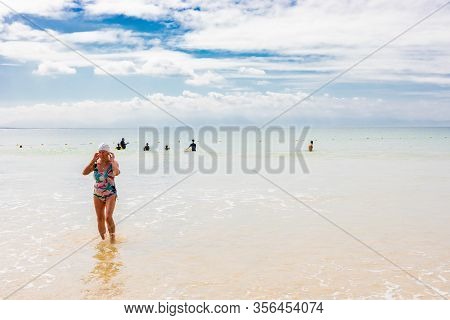 Swimmers Frolicking In The Shallow Waves Of Fish Hoek Beach