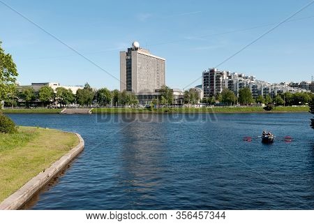 Saint-petersburg, Russia - May 30, 2019: People Row In A Boat On The Little Nevka River. On The Back