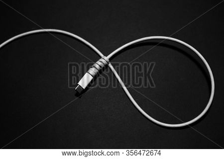 Close-up Of White Usb Type-c Charge Connector With Cable Protection On Black Background.