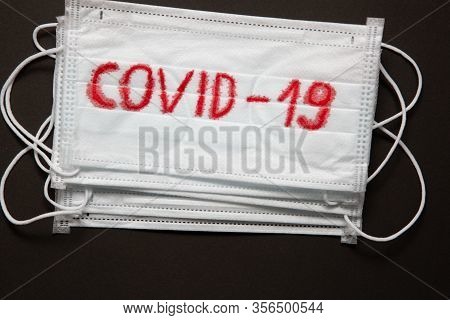 Medical Disposable Face Mask With Covid-19 Printed On It. Covid-19 - Wuhan Novel Coronavirus Pneumon