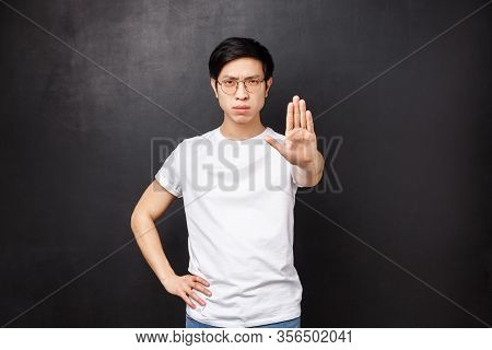 Caution Do Not Trespass. Serious-looking Confient And Angry Young Asian Guy Give Warning, Pull Arm F
