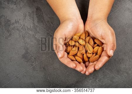 Prunus Dulcis - Hands Holding Peeled Almonds