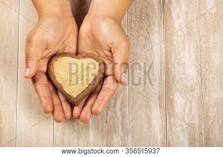 Lepidium Meyenii - Hands Holding Maca Powder