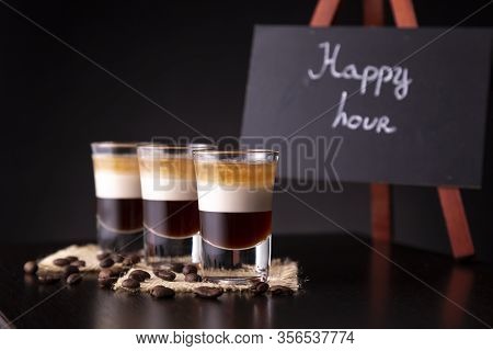 Three Shots Of B-52 Cocktail Placed On A Bar Counter