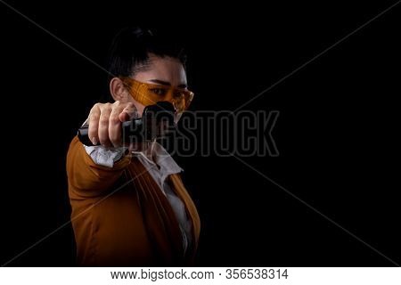 Women Pointing A Guns Look At The Camera, Portrait Beautiful Asea Woman Wearing A Yellow Suit One Ha